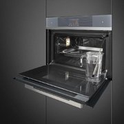 Компактный духовой шкаф с пароваркой Smeg SF4104WVCPS фото 2 в Краснодаре